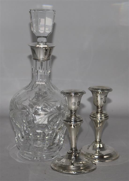 A decanter and a pair of silver candlesticks